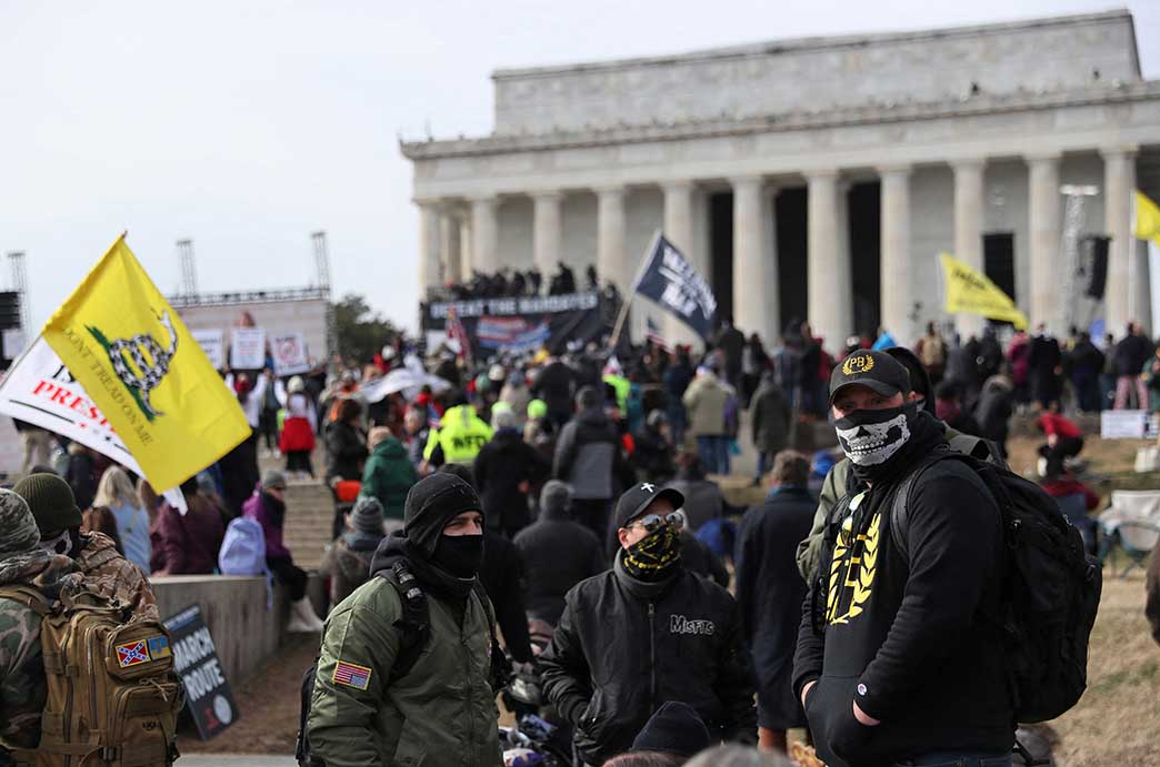 People dressed in colors and paraphernalia related to the Proud Boys People dressed in colors and paraphernalia related to the Proud Boys
