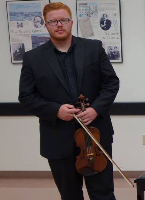 Antonio Foreman holding a violin