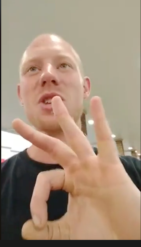 Tyler TenBrink, offering the "III percent" symbol on a Facebook live video