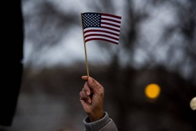 Carole Jackson waves an American flag