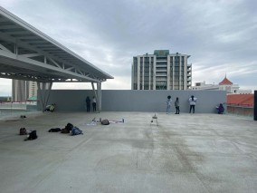 Students work on mural wall