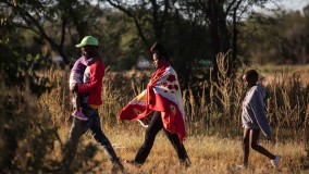 Immigrant family from Haiti walks in line to U.S. border with Mexico