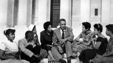 seven people sit around Thurgood Marshall