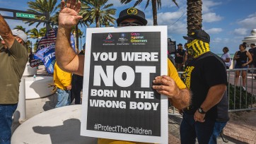 Person holds sign that reads: You were NOT born in the wrong body
