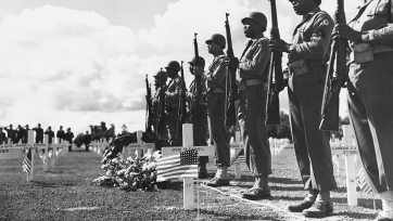 U.S. soldiers lined up near a grave
