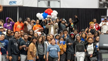 Artists and students crowd stage at Tougaloo College