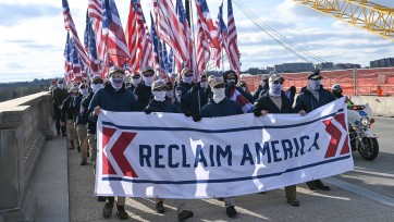 Patriot Front members march with "Reclaim America" banner