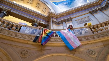 Pride flags hang from balcony inside Minnesota state Capitol