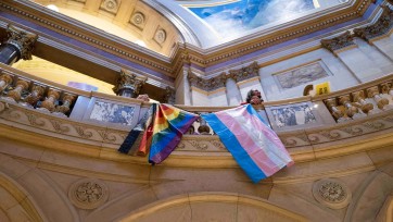 Pride flags hang from balcony inside Minnesota state Capitol