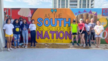 Student artists stand by finished mural at SPLC building