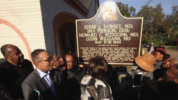 Crowd gathered around historical marker