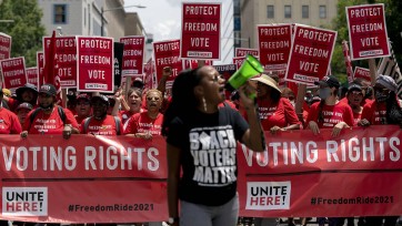 Demonstrators march during a Freedom Ride for Voting Rights rally 