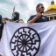 Members of Nationalist Social Club hold up hate group's flag