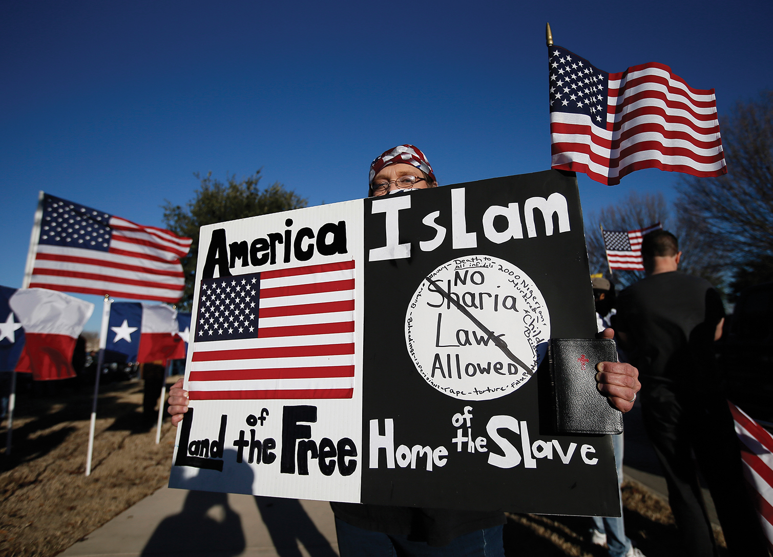 Man holds anti-Muslim sign