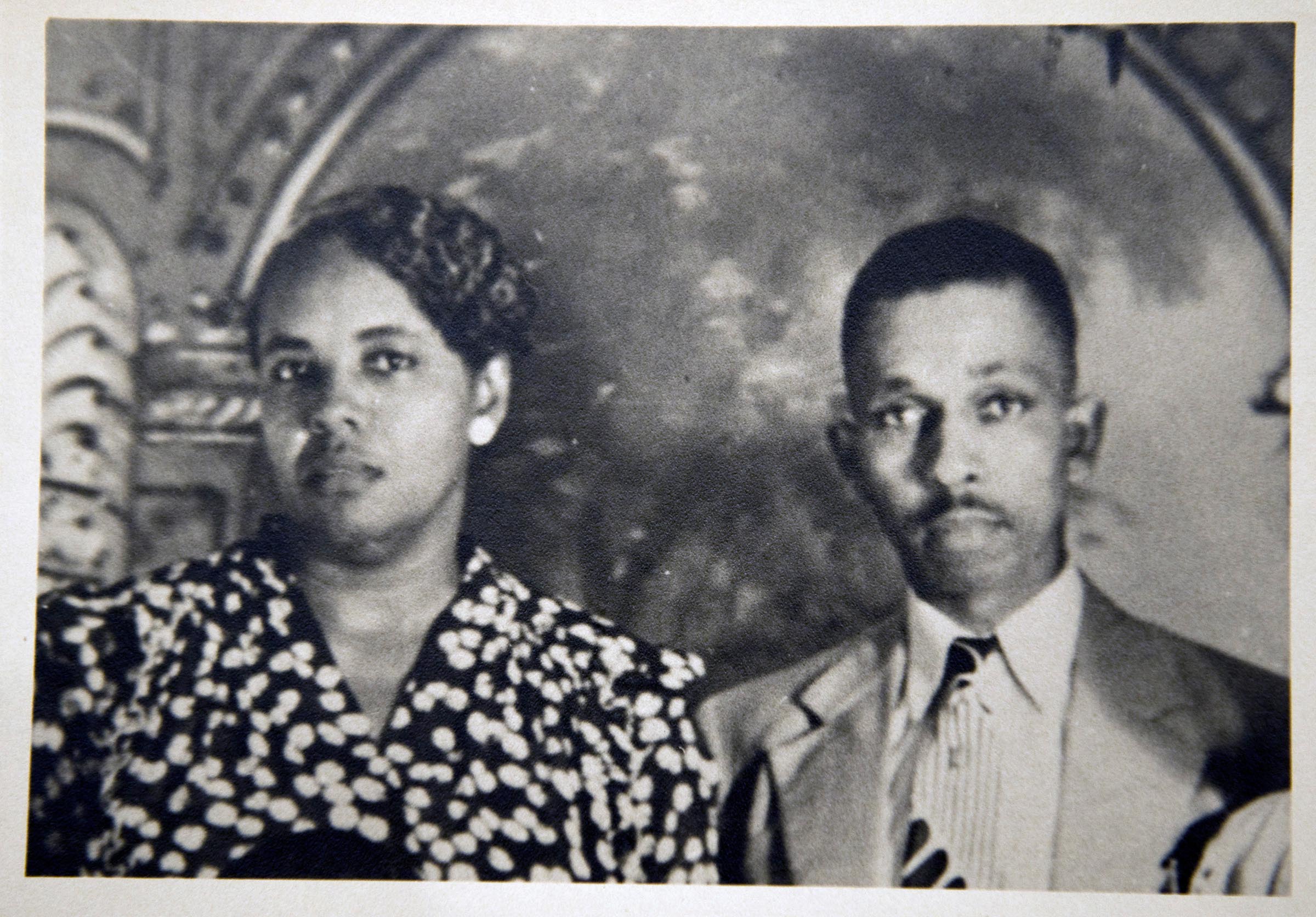 Black and white image featuring a woman and man.