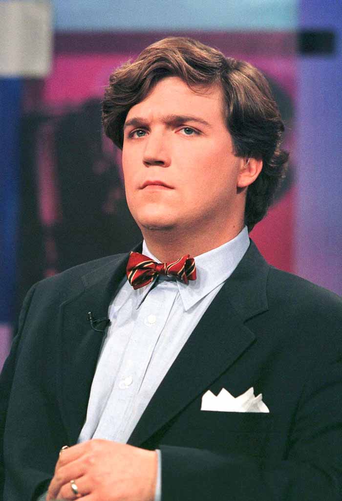 Tucker Carlson dressed in a bow tie and suit.