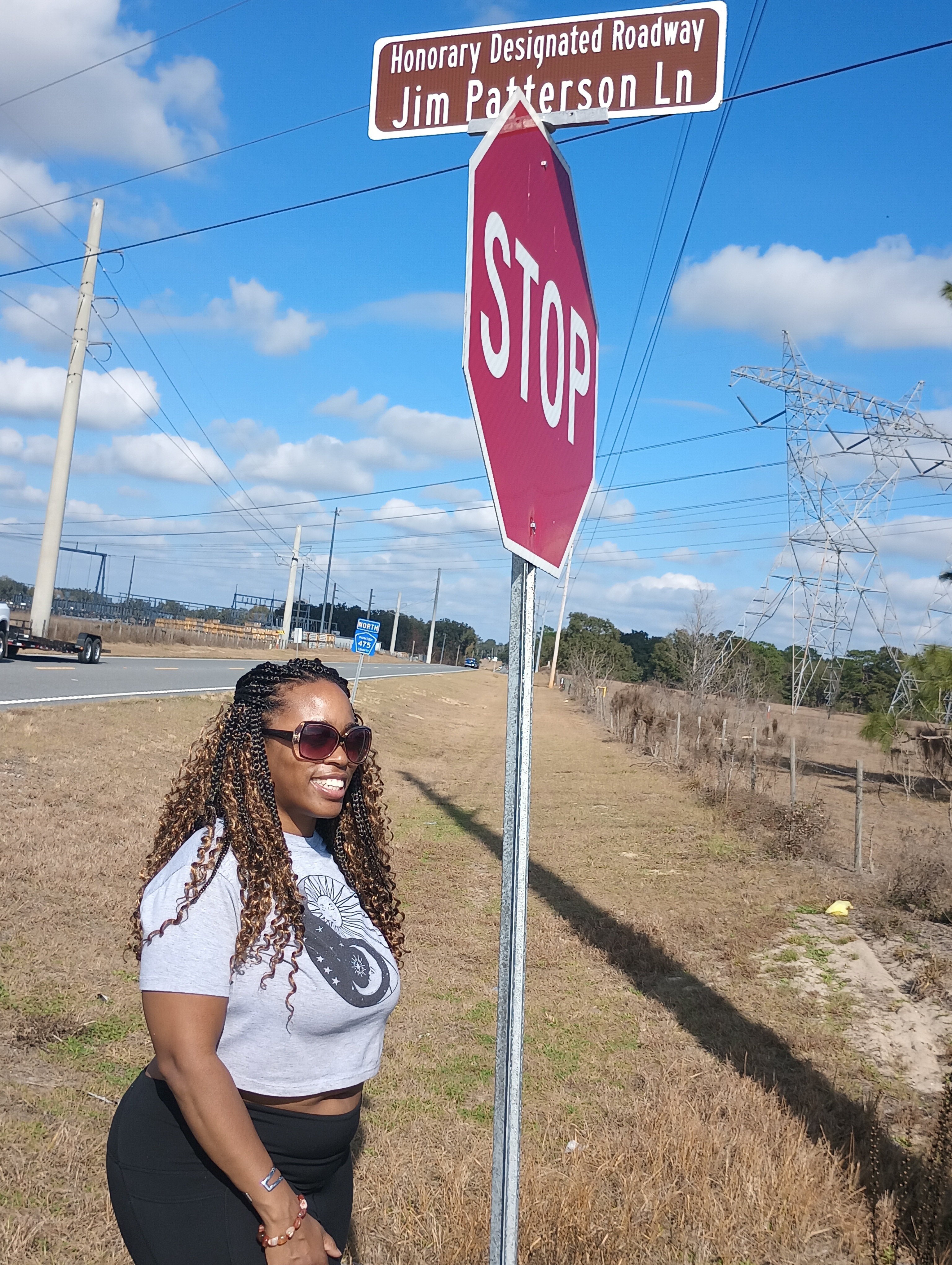 a woman standing next to a street sign