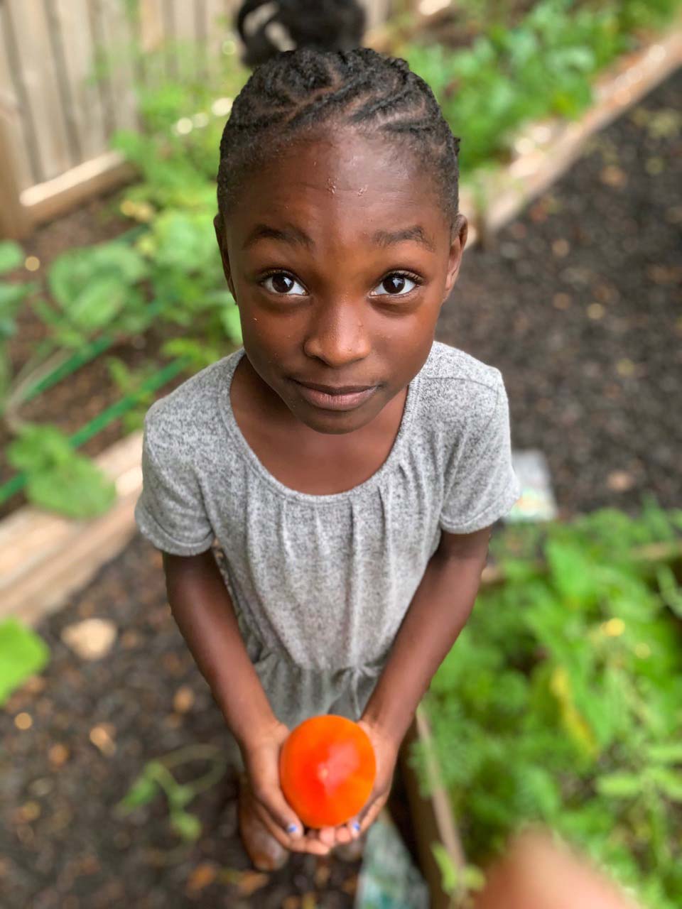 Kendall Rae Johnson holds a tomato