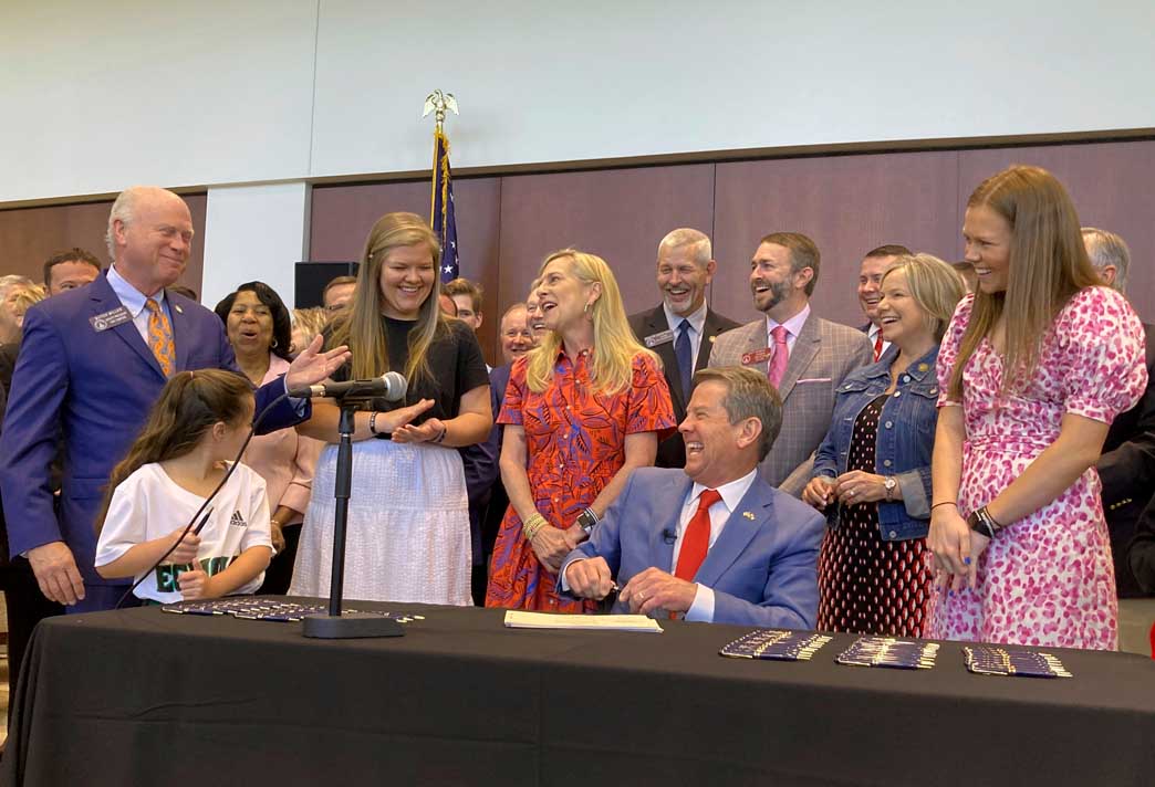 Georgia Governor Brian Kemp laughs after signing education bill into law Georgia Governor Brian Kemp laughs after signing education bill into law