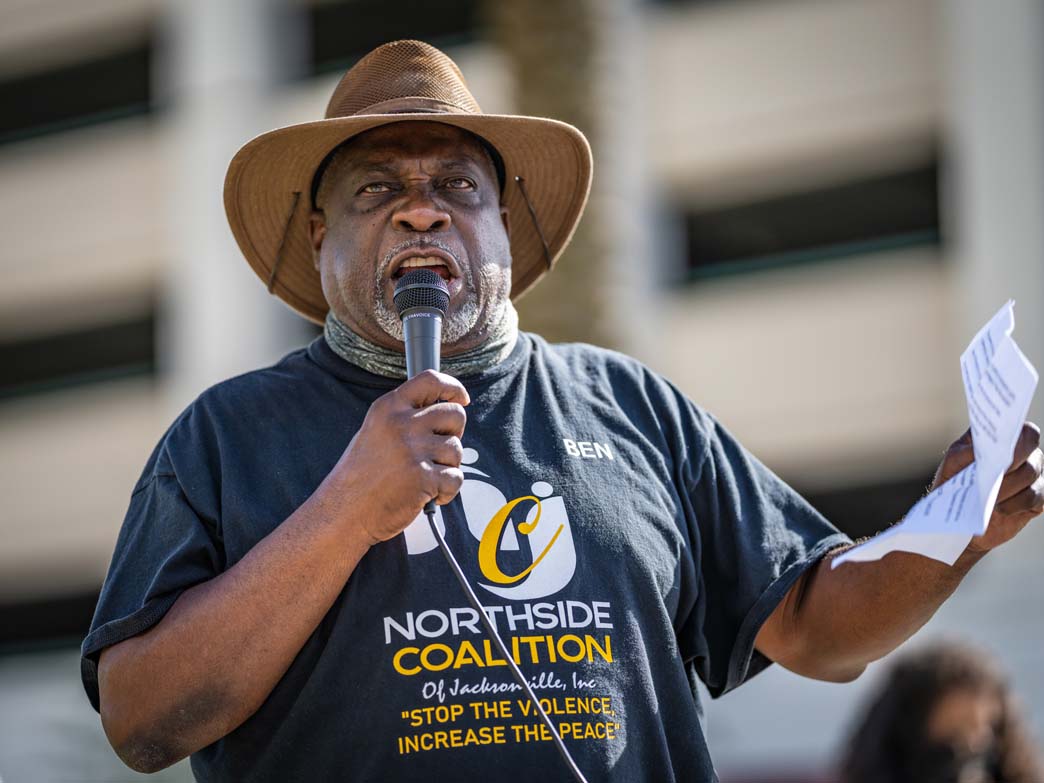 Ben Frazier holds microphone at rally