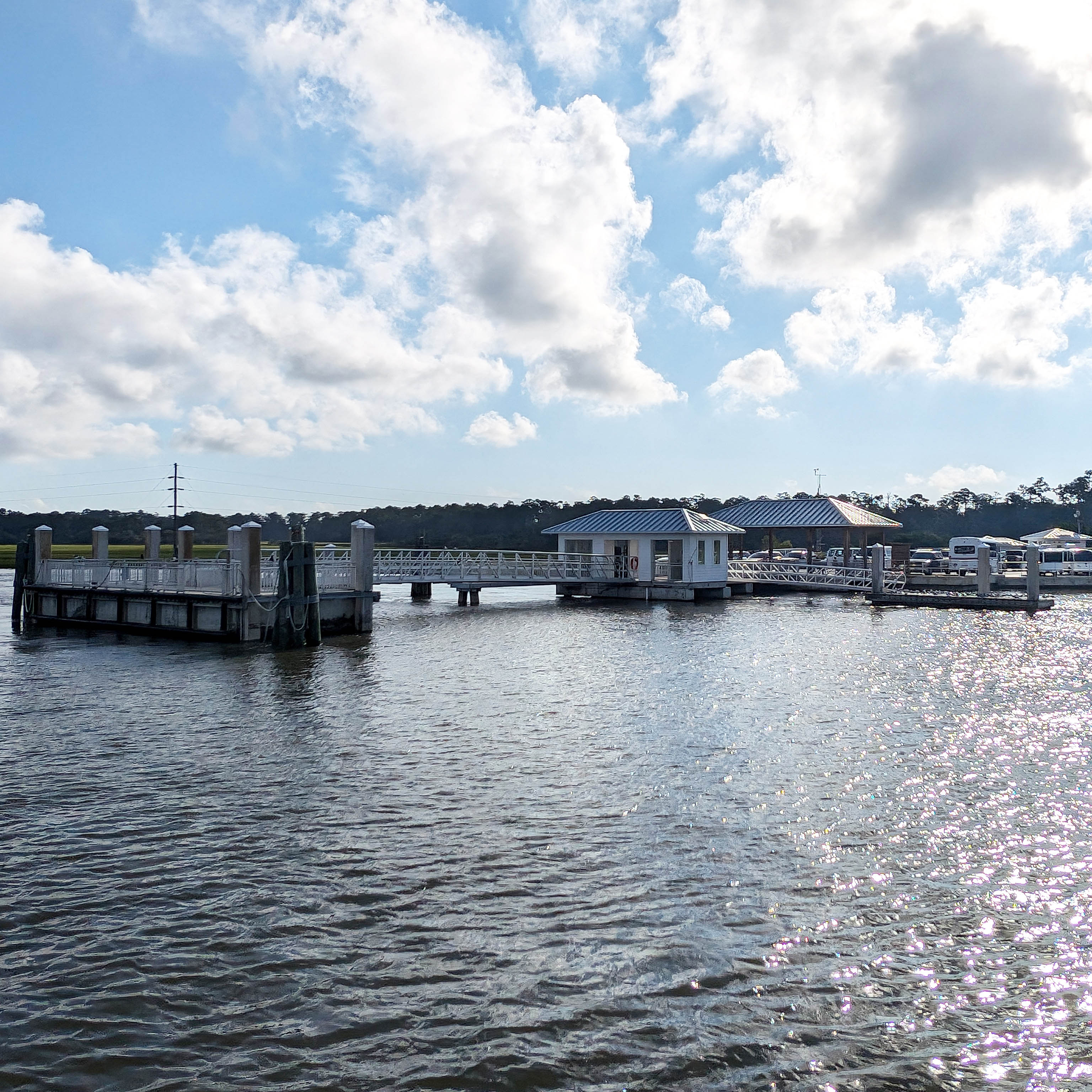 Calm waters under dock with cloudy skies above.