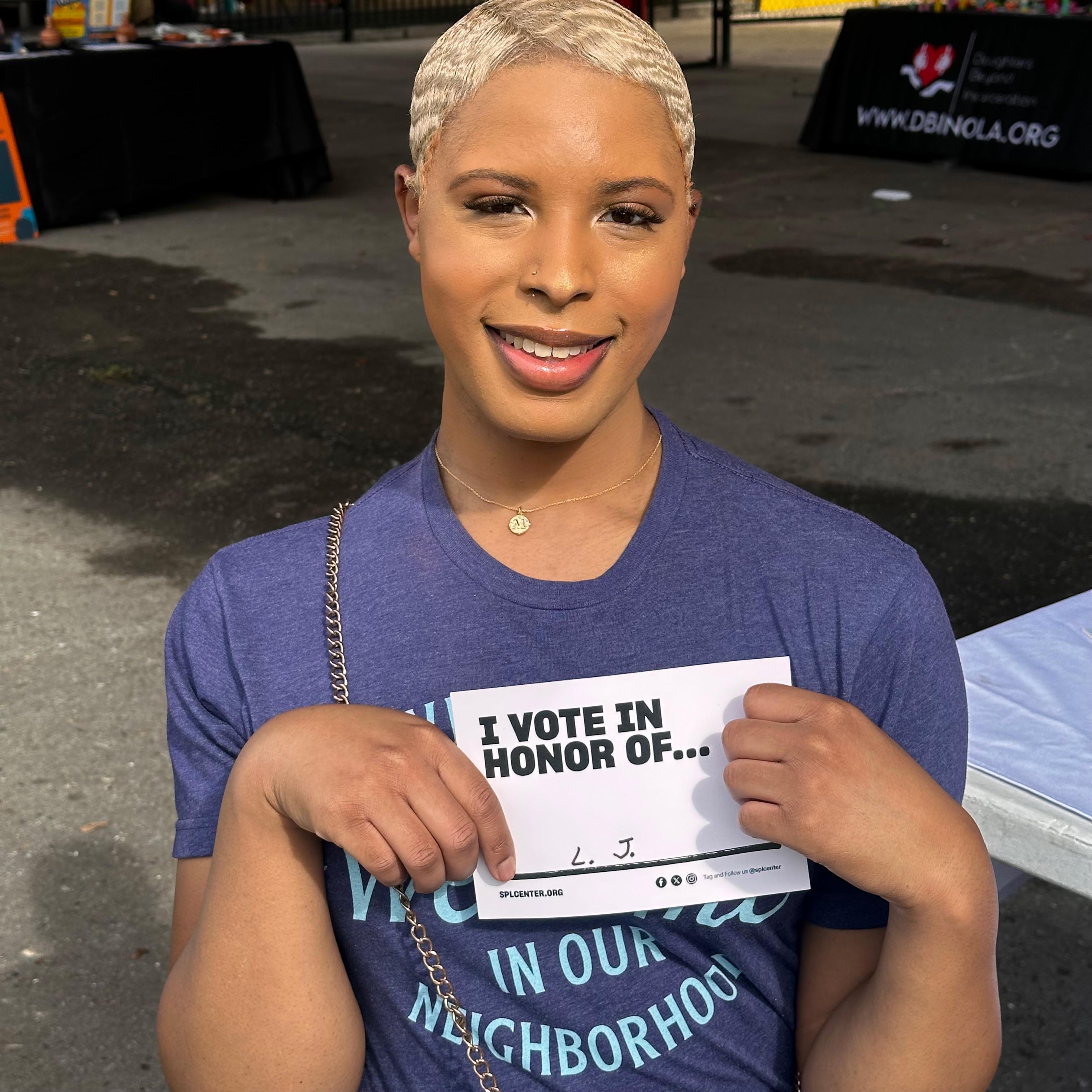 Person holds card with name of someone unable to vote.