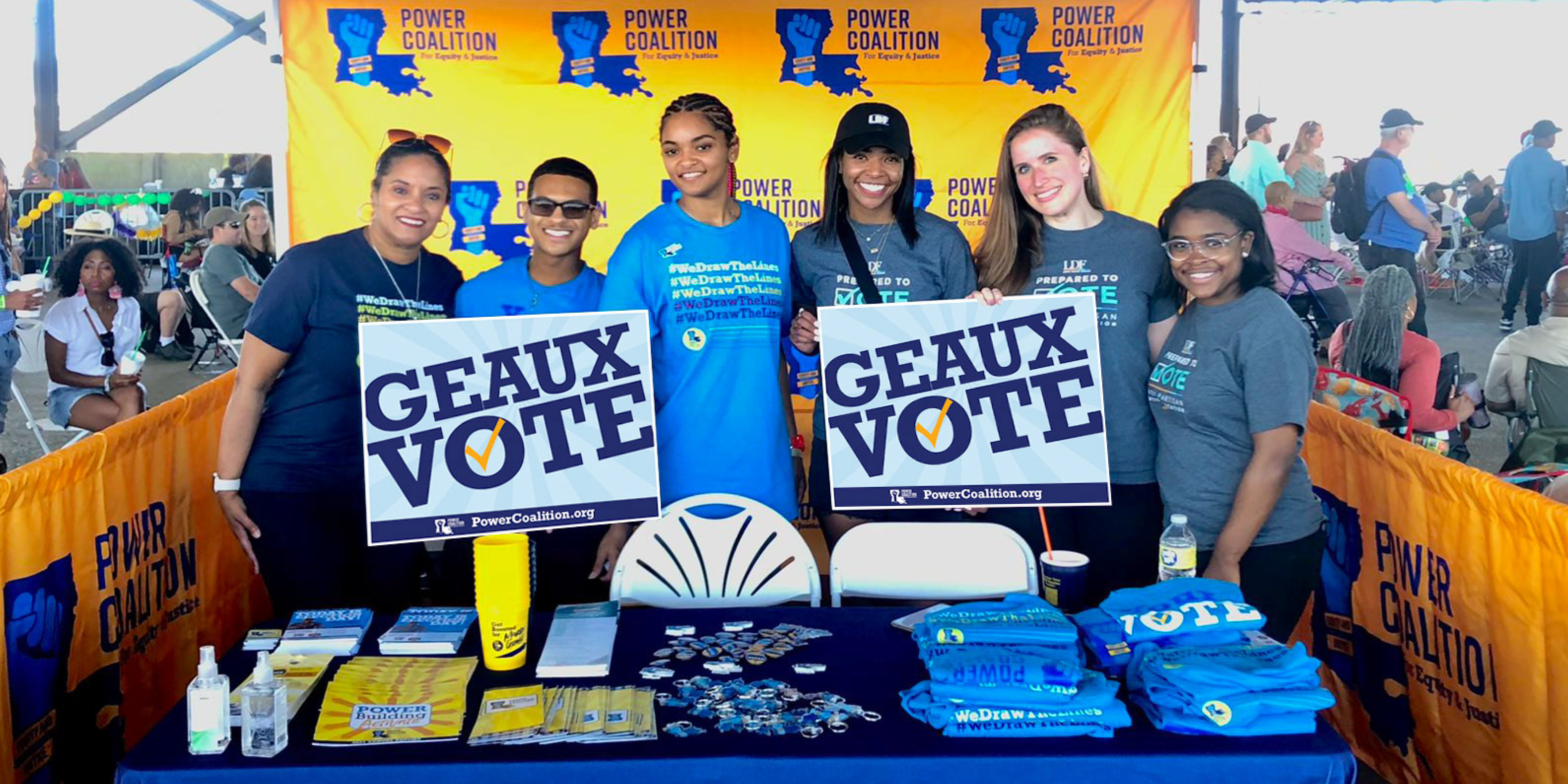 Six people hold up a sign that says "Geaux Vote"