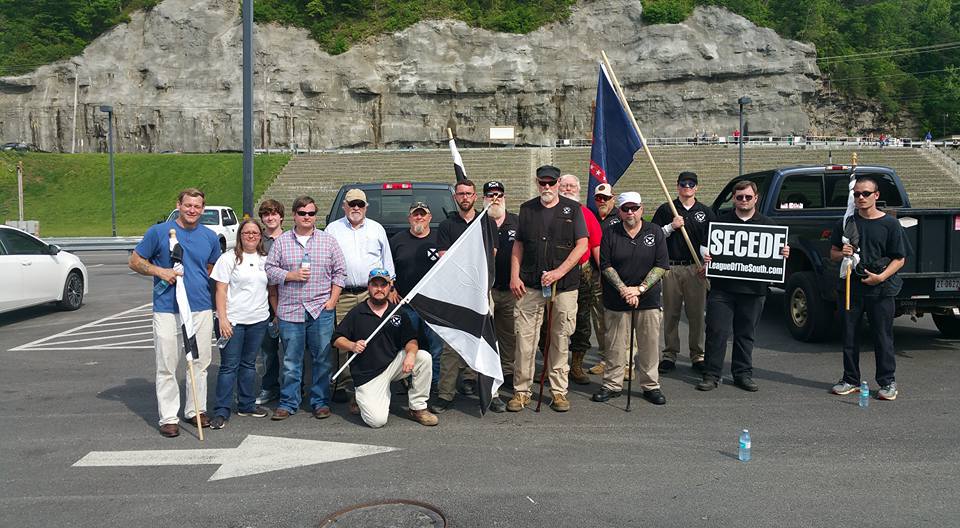 Pat Hines was present at the TWP Pikeville rally, photographed here in a red shirt peeking over Michael Hill’s left shoulder. 