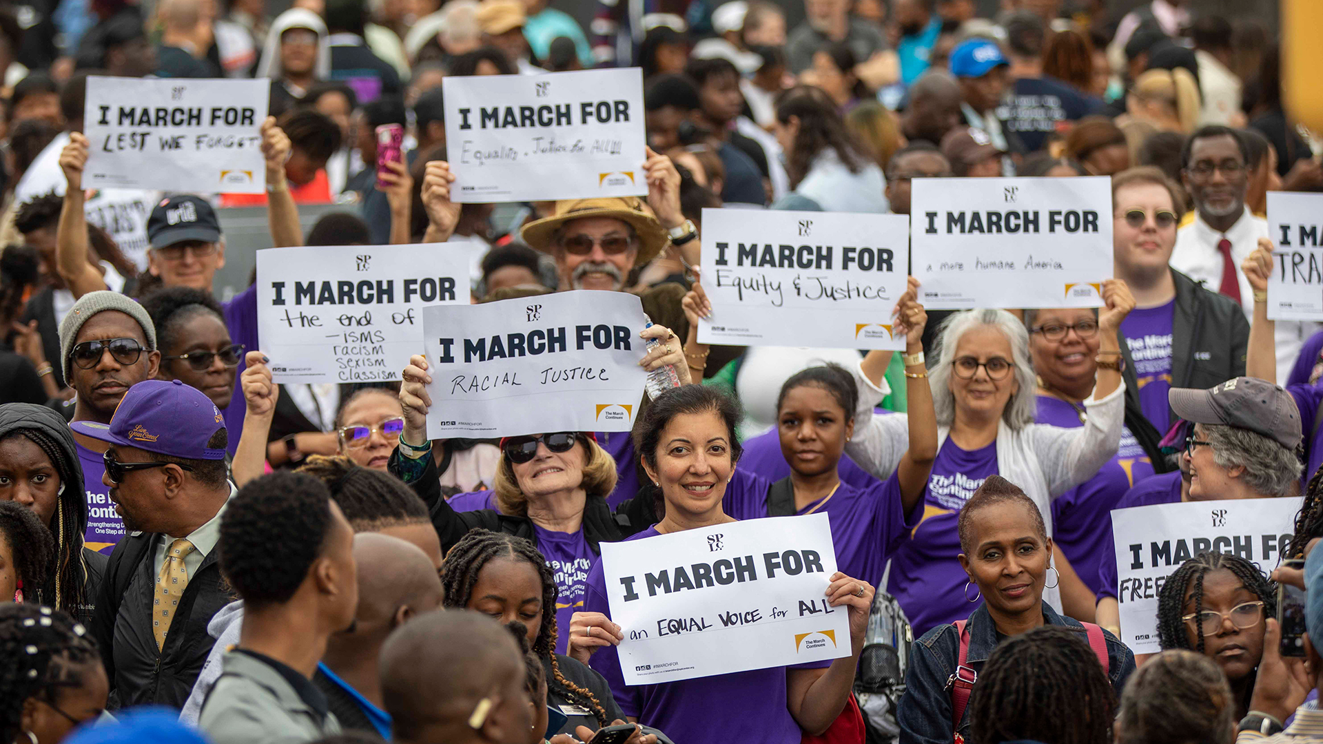 Marchers hold signs