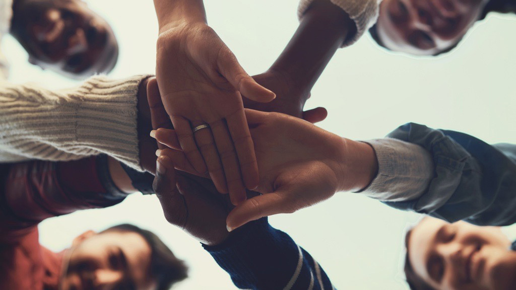 Hands in center of huddle.