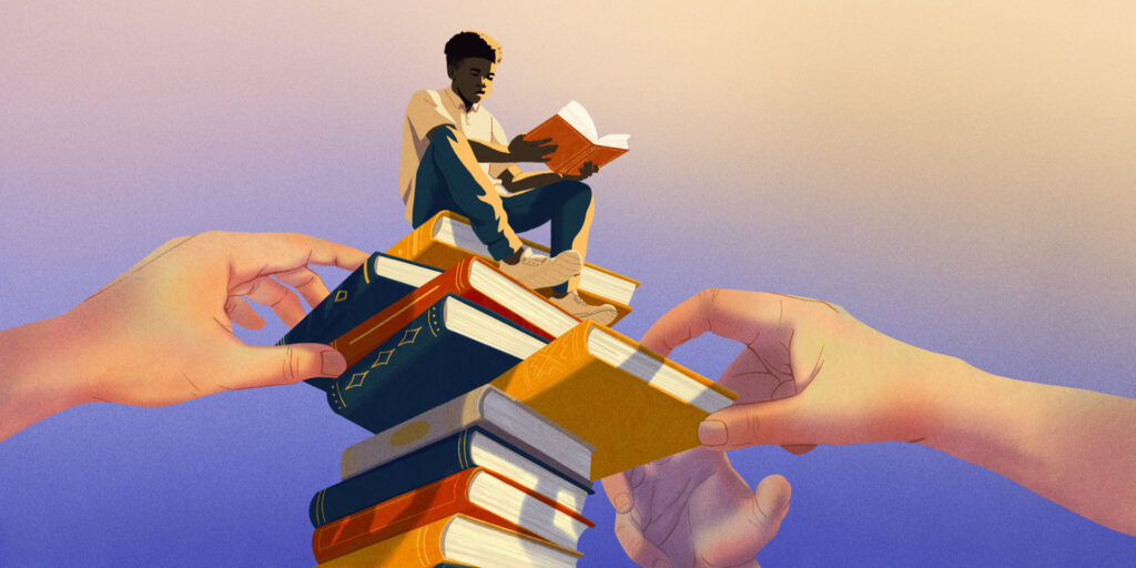 White hands remove books from a high stack where a black individual sits atop reading.