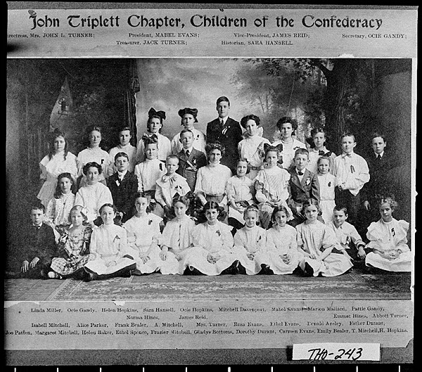 Newspaper clipping with picture of children seated in rows before a natural background.