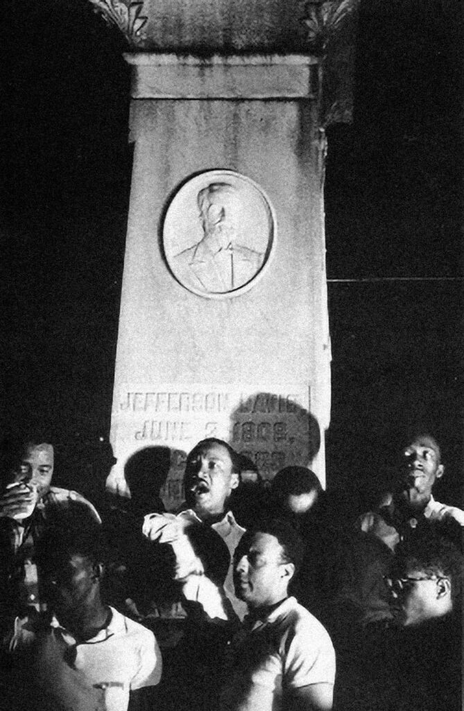 A group of people at the base of monument.