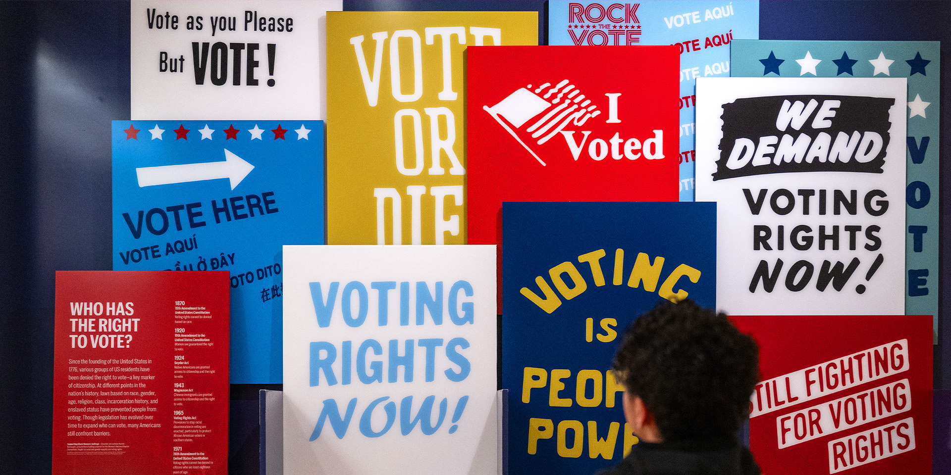 Person looking over voter encouragement signs.