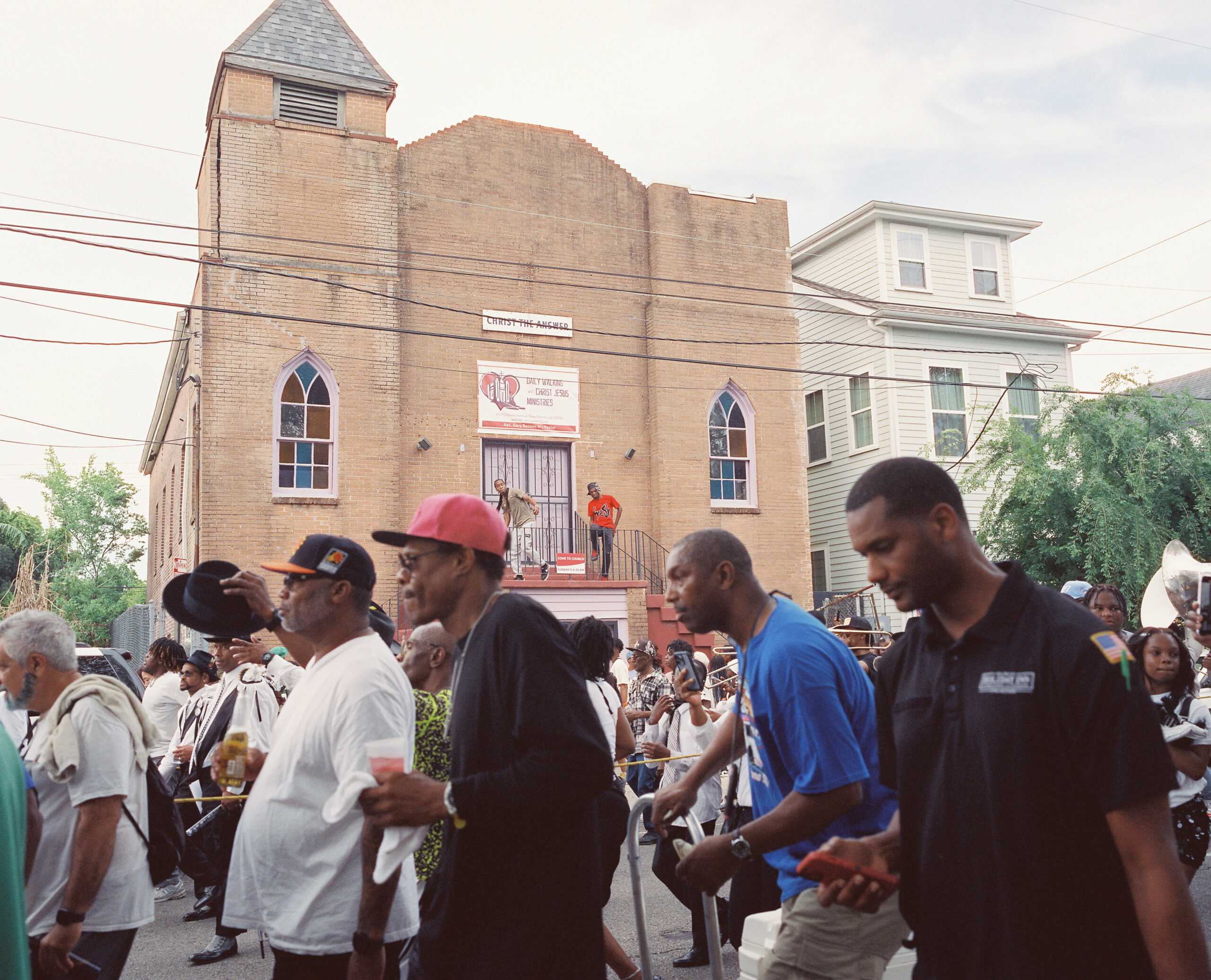 A group of people march through a street.