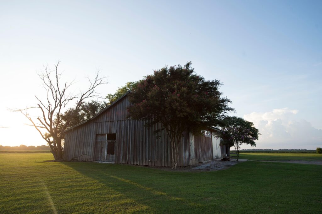 Exterior of building in a an open field as sun sets.