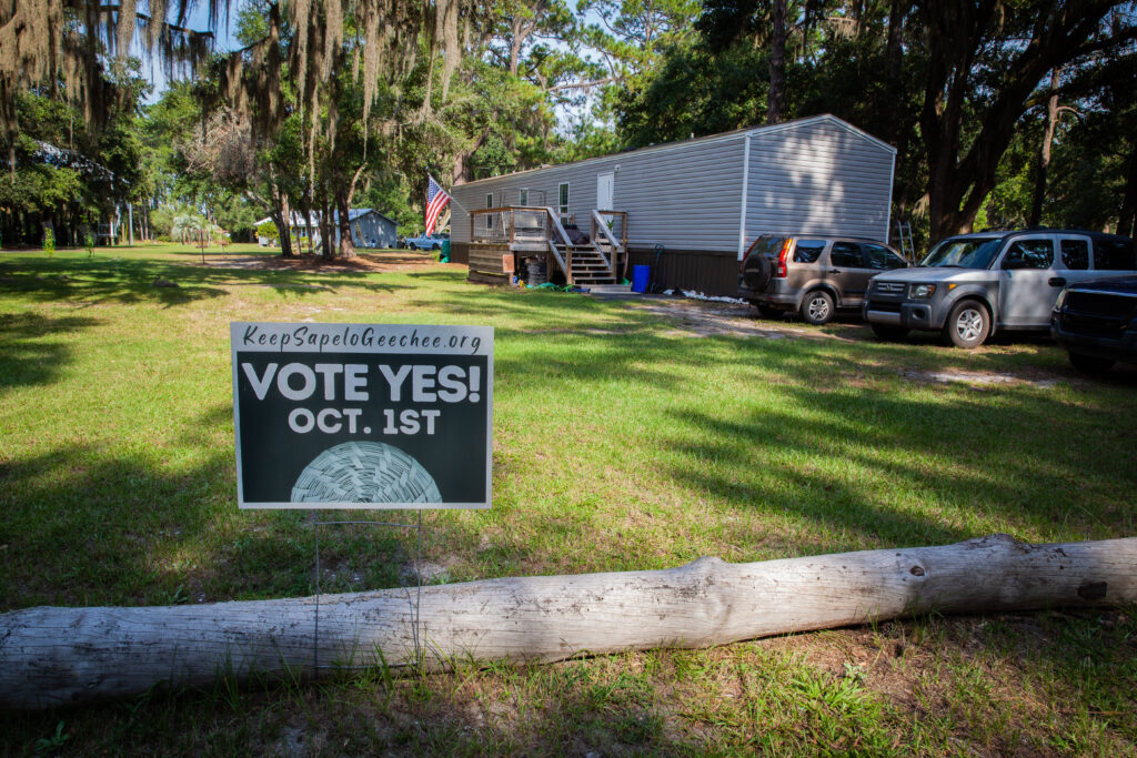Sign encourages voters on a lawn.