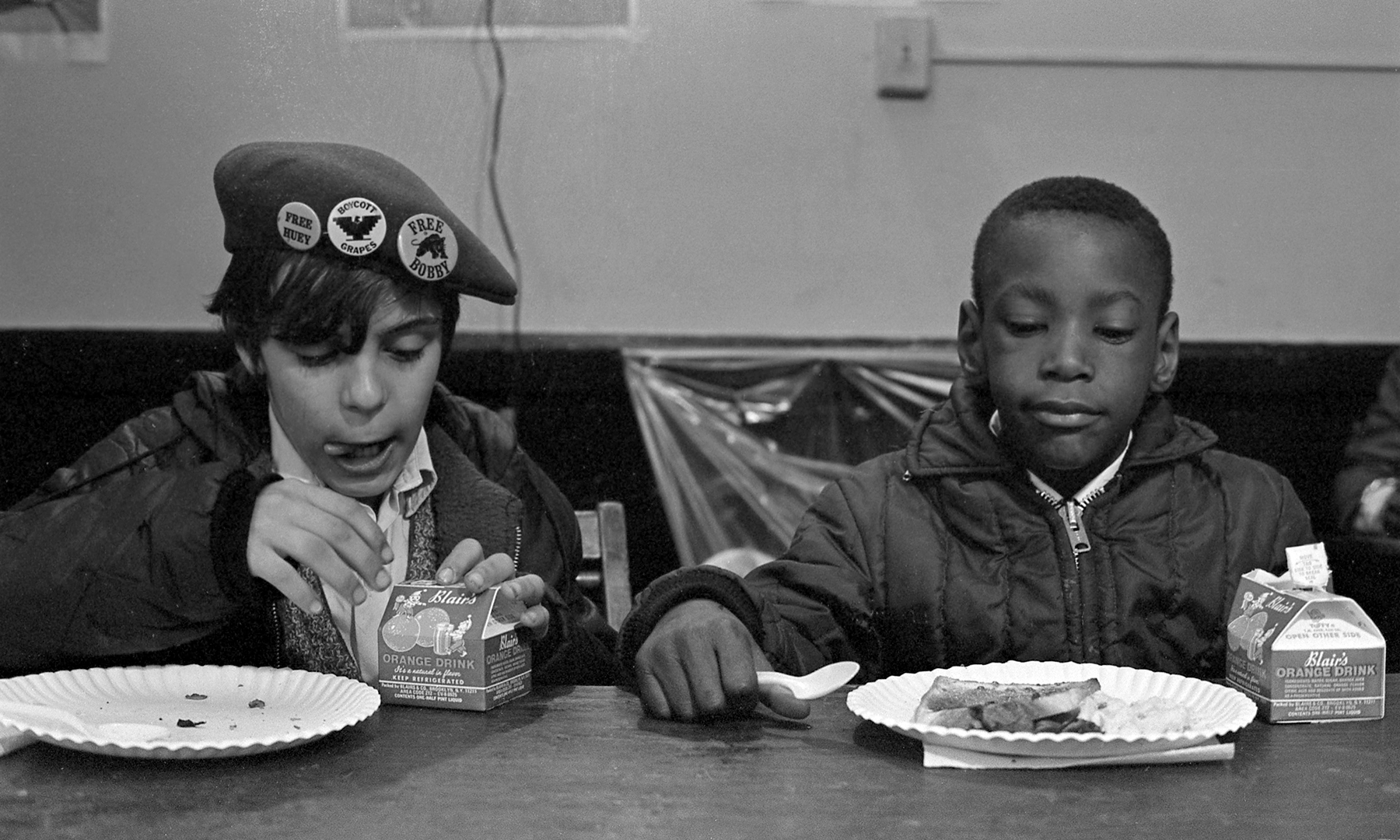 Two kids eating breakfast together.