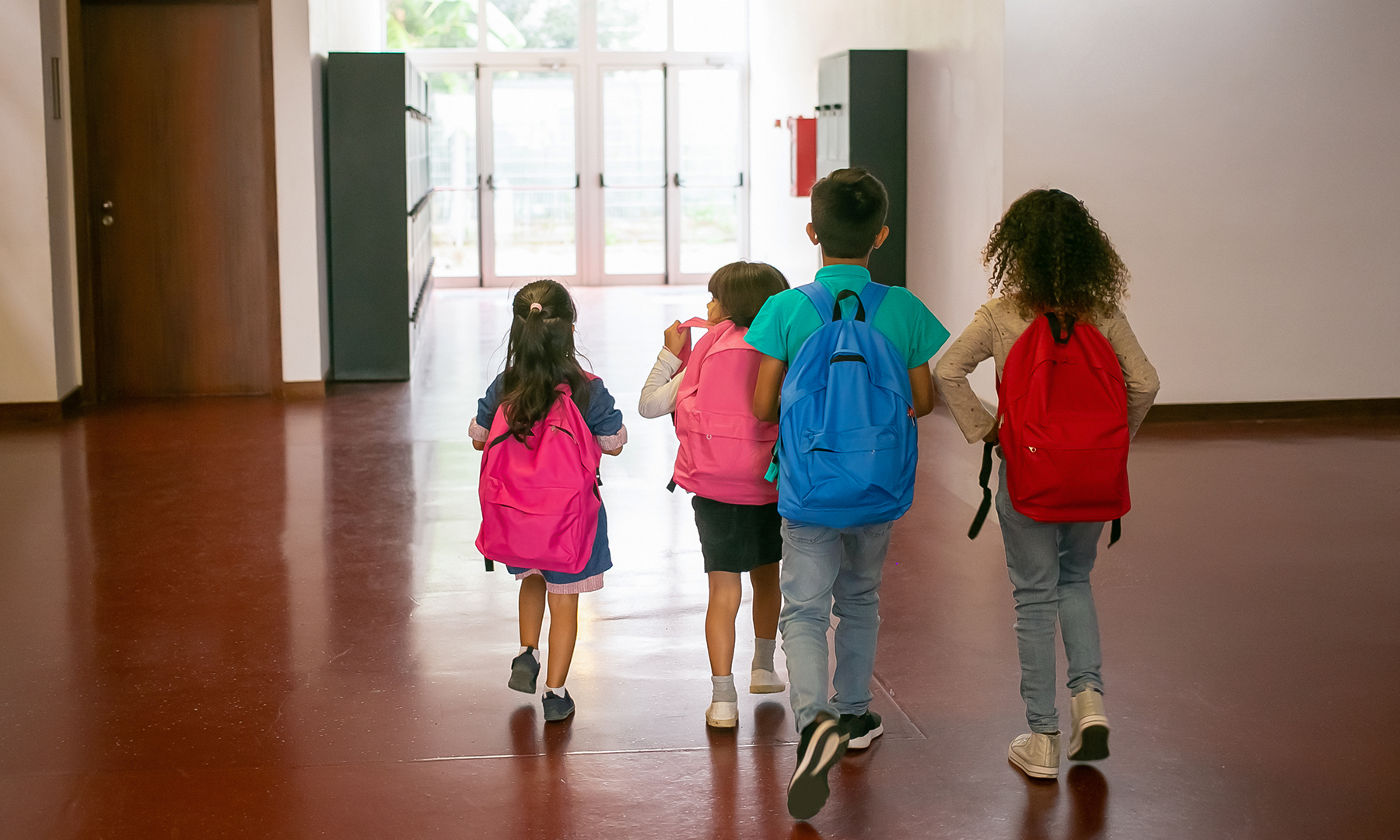 Diverse children walking in school