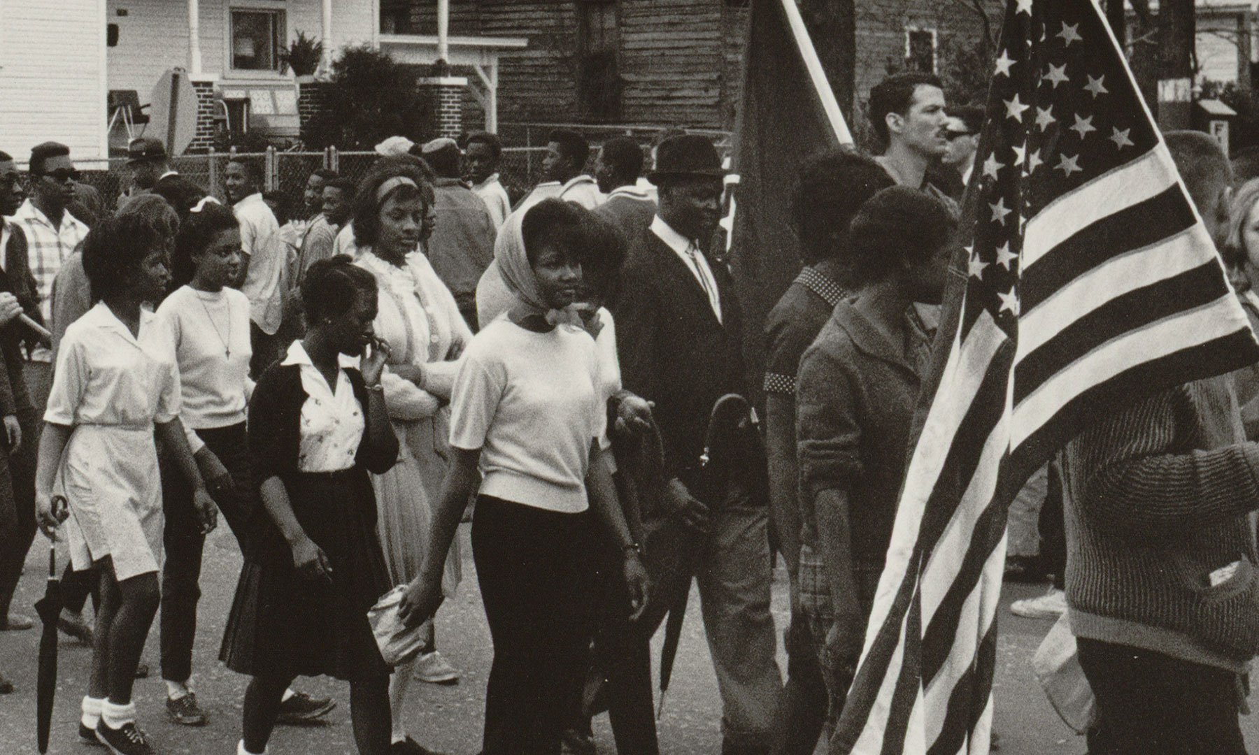Archival photo of civil rights activists marching.