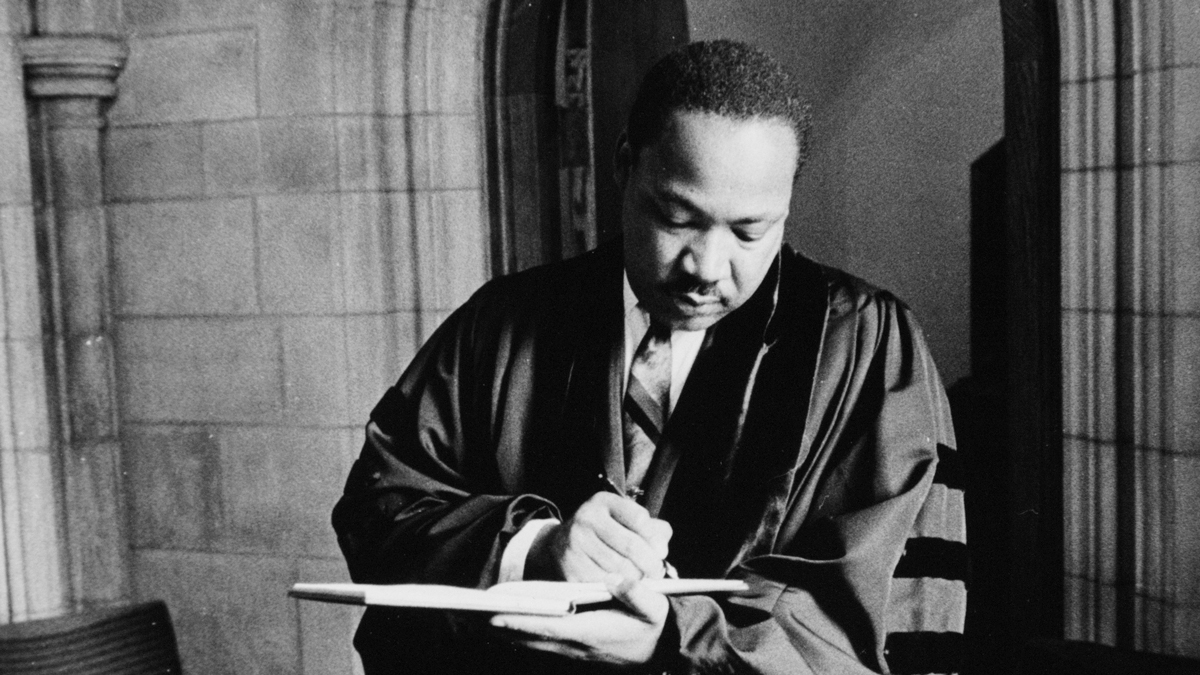MLK writing in pastoral robe