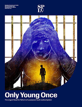 African American youth with their hands on their head, standing before bars